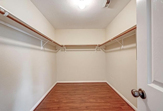 15251 Weeping Cedar Ln, Houston, TX 77084 - walk in closet featuring wood finished floors