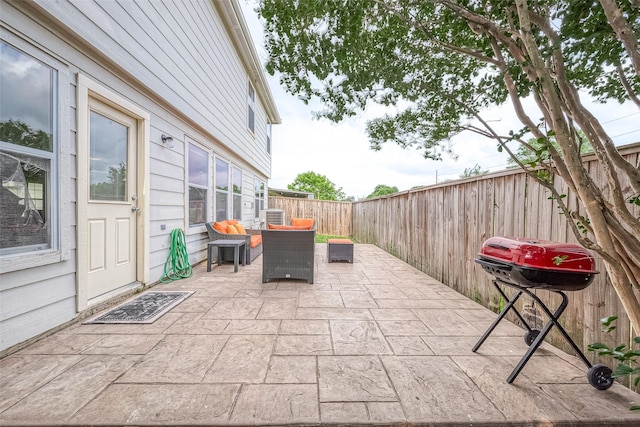 15251 Weeping Cedar Ln, Houston, TX 77084 - fenced backyard featuring a patio area, central AC unit, grilling area, and outdoor lounge area
