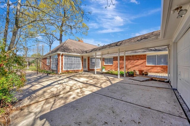 15510 Park Estates Ln, Houston, TX 77062 - rear view of property featuring brick siding and a chimney