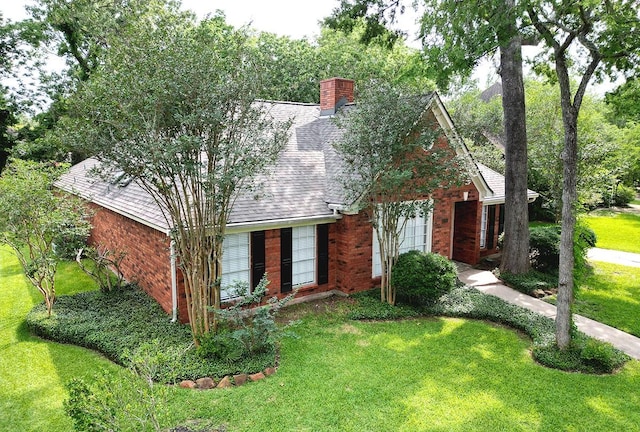 15510 Park Estates Ln, Houston, TX 77062 - view of front facade featuring brick siding, a front yard, and a chimney