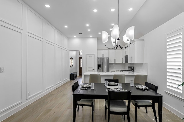24203 Leonforte Dr, Richmond, TX 77406 - dining room featuring recessed lighting, light wood-type flooring, a chandelier, and baseboards
