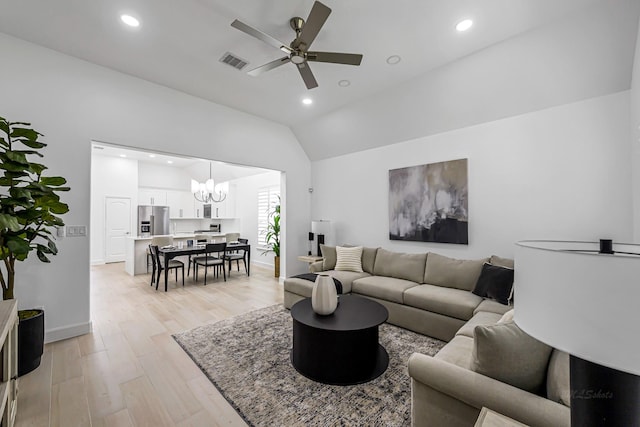 24203 Leonforte Dr, Richmond, TX 77406 - living area featuring lofted ceiling, light wood-style floors, a ceiling fan, a chandelier, and recessed lighting