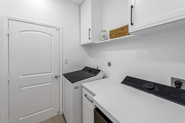 24203 Leonforte Dr, Richmond, TX 77406 - laundry room featuring washer and clothes dryer and cabinet space