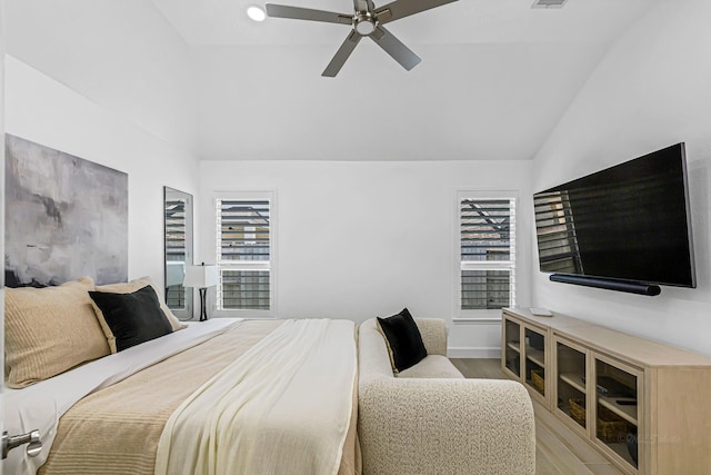 24203 Leonforte Dr, Richmond, TX 77406 - bedroom with light wood-style flooring, multiple windows, vaulted ceiling, and a ceiling fan