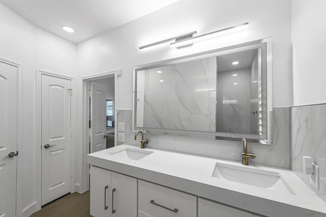 24203 Leonforte Dr, Richmond, TX 77406 - bathroom featuring double vanity, wood finished floors, and recessed lighting