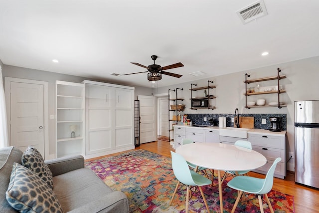 3222 Oakmont St, Houston, TX 77021 - living room with light wood finished floors, ceiling fan, and recessed lighting