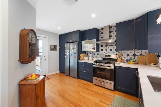 3222 Oakmont St, Houston, TX 77021 - kitchen with stainless steel appliances, wall chimney range hood, light countertops, tasteful backsplash, and recessed lighting