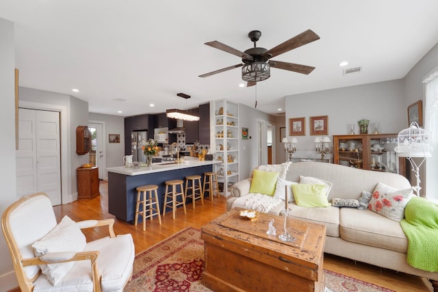 3222 Oakmont St, Houston, TX 77021 - living area with ceiling fan, recessed lighting, and light wood finished floors
