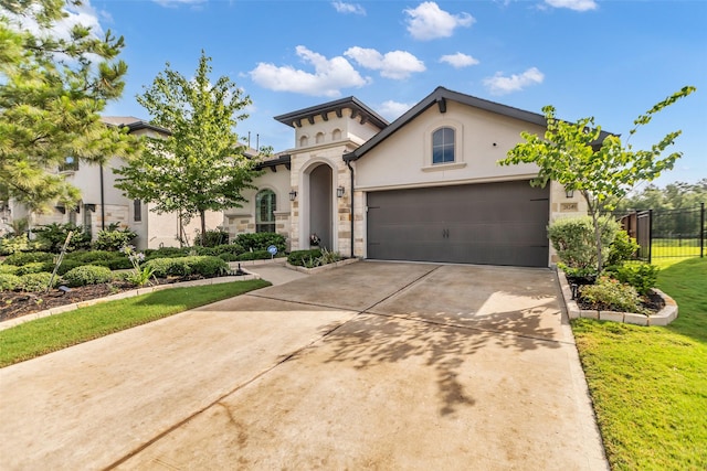 28249 Woodland Bend Way, Spring, TX 77386 - mediterranean / spanish-style home featuring stucco siding, concrete driveway, an attached garage, and stone siding