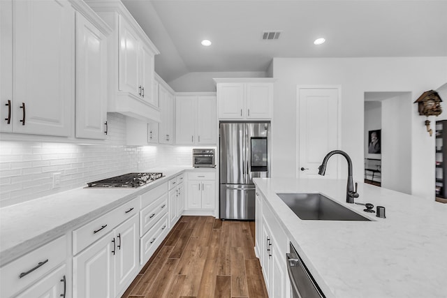 28249 Woodland Bend Way, Spring, TX 77386 - kitchen featuring stainless steel appliances, a sink, white cabinets, light stone countertops, and recessed lighting