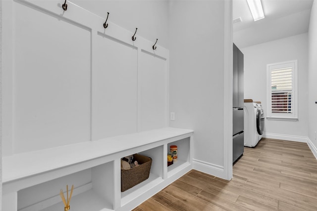 28249 Woodland Bend Way, Spring, TX 77386 - mudroom with washer / clothes dryer, baseboards, and light wood finished floors