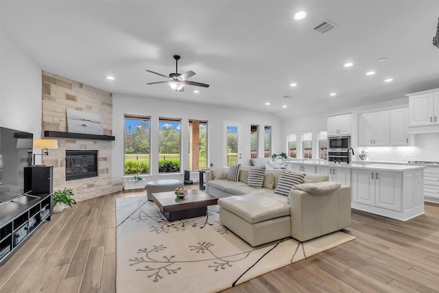 28249 Woodland Bend Way, Spring, TX 77386 - living room featuring healthy amount of natural light, a fireplace, recessed lighting, and light wood finished floors