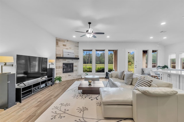 28249 Woodland Bend Way, Spring, TX 77386 - living area with wood finished floors, a ceiling fan, recessed lighting, and a stone fireplace