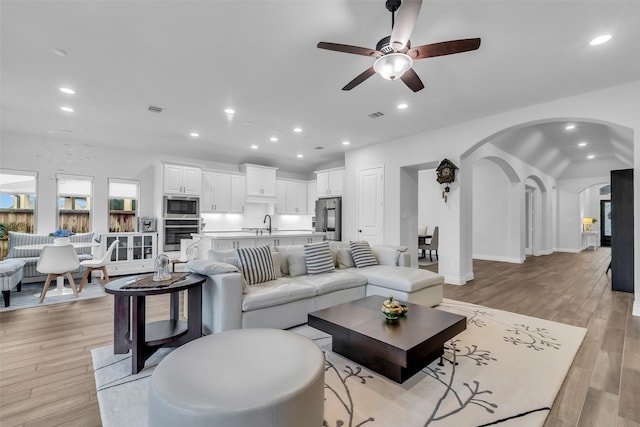 28249 Woodland Bend Way, Spring, TX 77386 - living area with arched walkways, a ceiling fan, recessed lighting, vaulted ceiling, and light wood finished floors