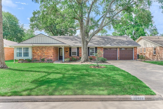 10411 Londonderry Dr, Houston, TX 77043 - ranch-style house with an attached garage, brick siding, concrete driveway, a front lawn, and board and batten siding