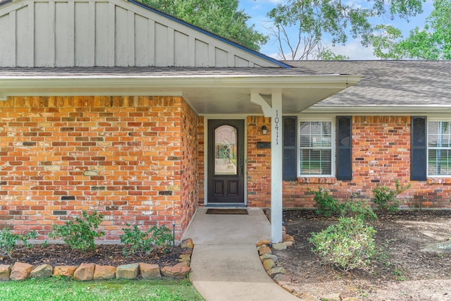 10411 Londonderry Dr, Houston, TX 77043 - view of exterior entry featuring brick siding and a shingled roof
