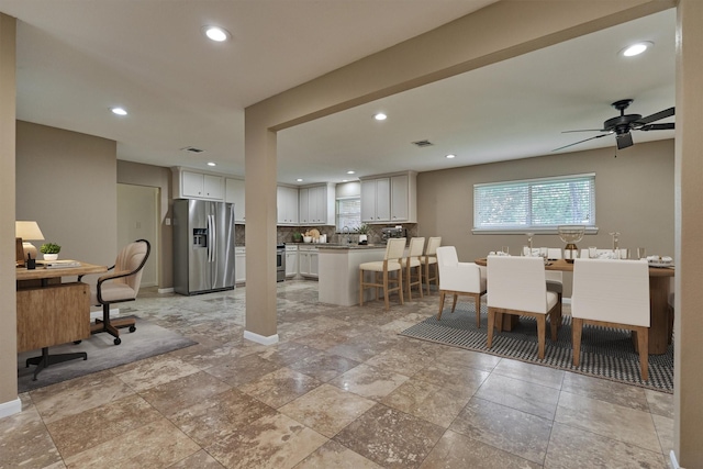 10411 Londonderry Dr, Houston, TX 77043 - dining area featuring baseboards, ceiling fan, recessed lighting, an office area, and stone tile floors