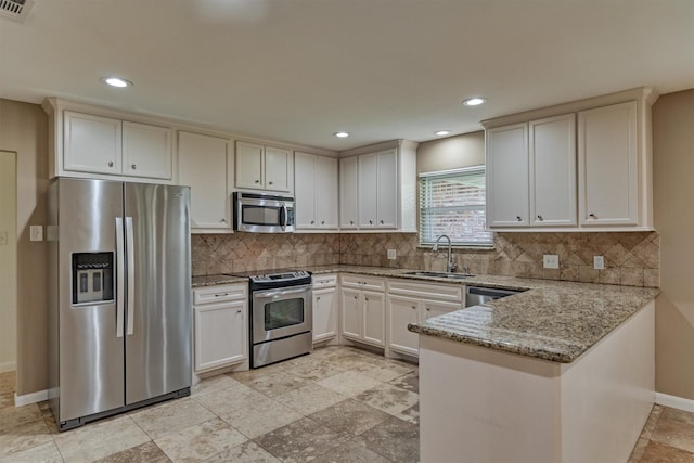 10411 Londonderry Dr, Houston, TX 77043 - kitchen featuring stainless steel appliances, a sink, a peninsula, baseboards, and backsplash
