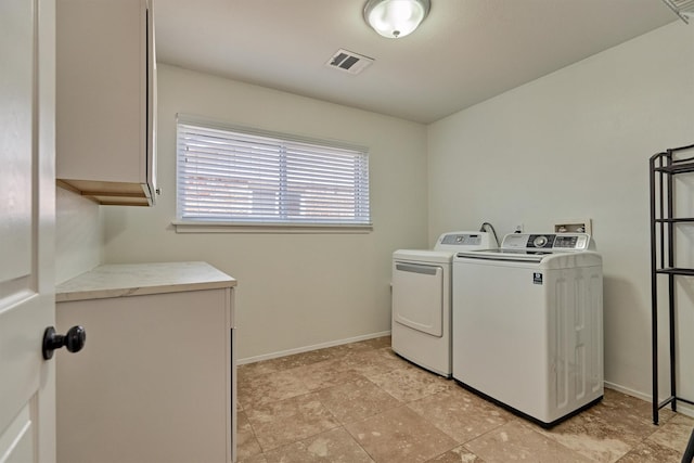 10411 Londonderry Dr, Houston, TX 77043 - washroom with cabinet space, washing machine and dryer, and baseboards