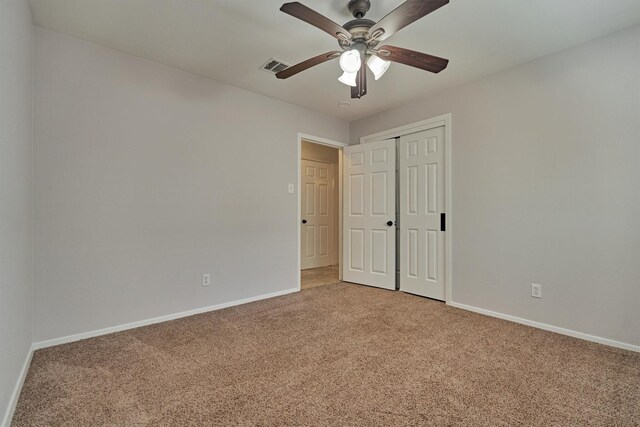 10411 Londonderry Dr, Houston, TX 77043 - unfurnished bedroom with light colored carpet, baseboards, a closet, and ceiling fan