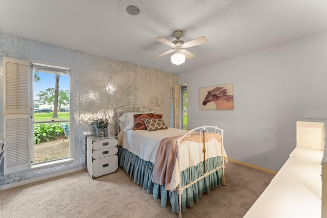 9809 Neuens Rd, Houston, TX 77080 - bedroom featuring multiple windows, light carpet, baseboards, wallpapered walls, and a ceiling fan
