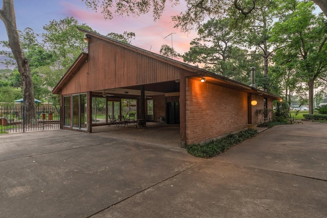 9809 Neuens Rd, Houston, TX 77080 - view of side of home with driveway, brick siding, and a carport