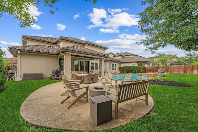 5823 Stratton Woods Dr, Spring, TX 77389 - back of house with a fire pit, a ceiling fan, a patio, a tiled roof, and stucco siding