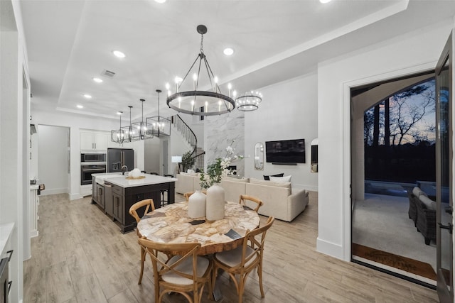 324 S Opulent Dr, Montgomery, TX 77316 - dining space with a chandelier, recessed lighting, light wood-style flooring, baseboards, and a raised ceiling