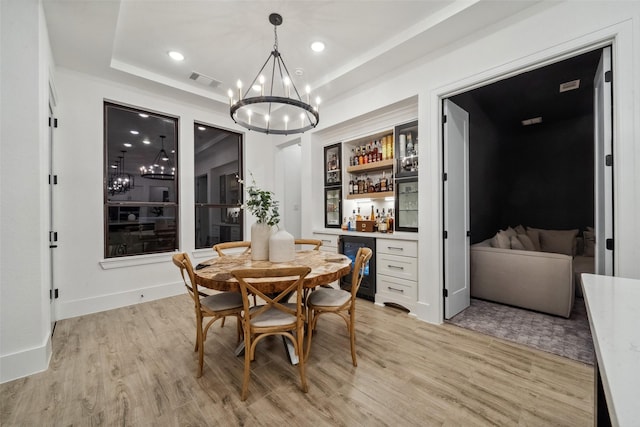 324 S Opulent Dr, Montgomery, TX 77316 - dining room featuring a chandelier, a bar, beverage cooler, light wood-style floors, and recessed lighting