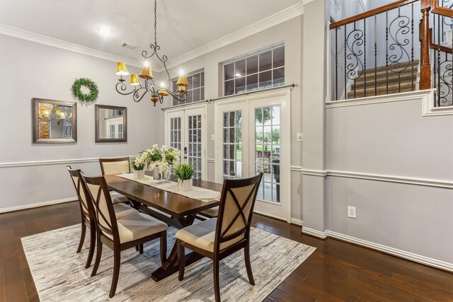 7014 Lake Haven Ct, Sugar Land, TX 77479 - dining area with a chandelier, wood-type flooring, crown molding, baseboards, and french doors