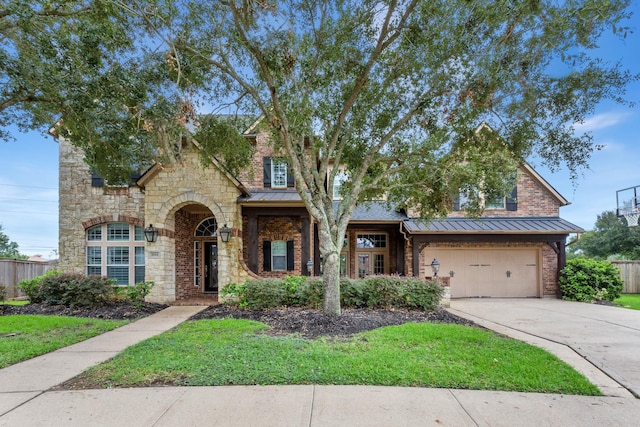 7014 Lake Haven Ct, Sugar Land, TX 77479 - view of front of home featuring a standing seam roof, concrete driveway, a garage, and stone siding