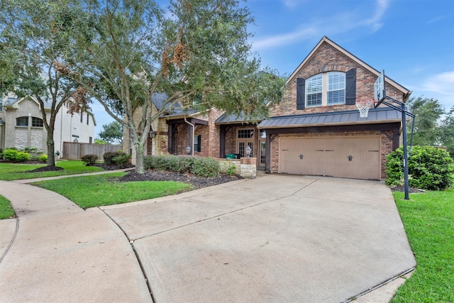 7014 Lake Haven Ct, Sugar Land, TX 77479 - view of front of property with brick siding, a garage, concrete driveway, a standing seam roof, and metal roof