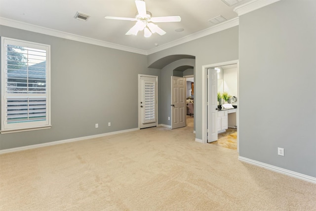 7014 Lake Haven Ct, Sugar Land, TX 77479 - spare room with light colored carpet, arched walkways, crown molding, ceiling fan, and baseboards