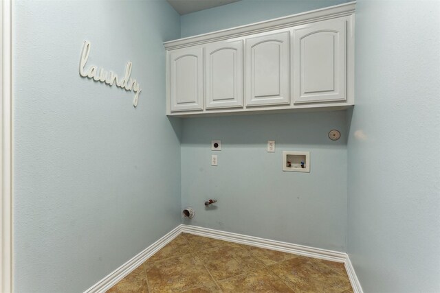 7014 Lake Haven Ct, Sugar Land, TX 77479 - laundry area featuring hookup for a gas dryer, washer hookup, baseboards, cabinet space, and electric dryer hookup