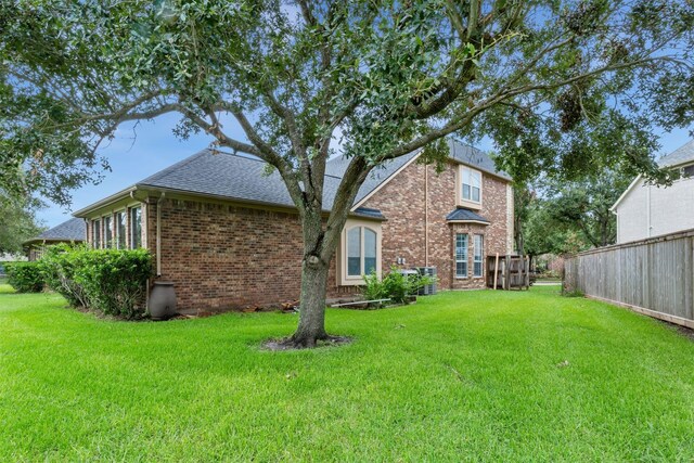 7014 Lake Haven Ct, Sugar Land, TX 77479 - back of property featuring brick siding and a shingled roof