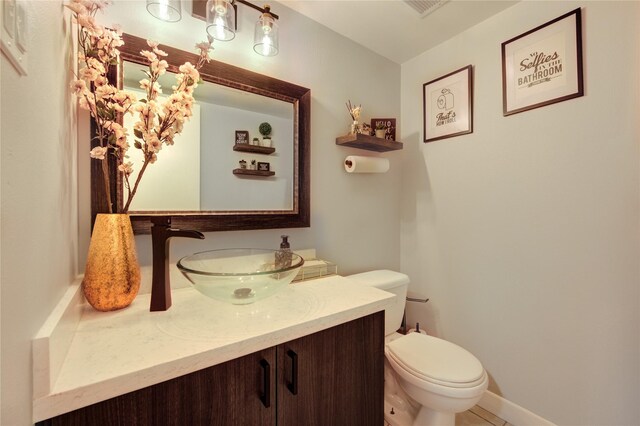 2246 Triway Ln, Houston, TX 77043 - bathroom with vanity, toilet, baseboards, and tile patterned floors