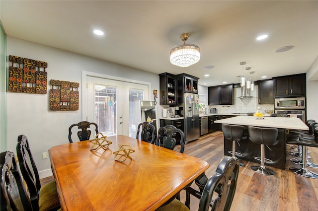 2246 Triway Ln, Houston, TX 77043 - dining area featuring light wood finished floors, french doors, recessed lighting, and a chandelier