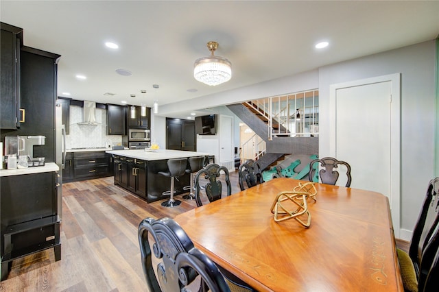 2246 Triway Ln, Houston, TX 77043 - dining room with stairway, light wood-style flooring, and recessed lighting