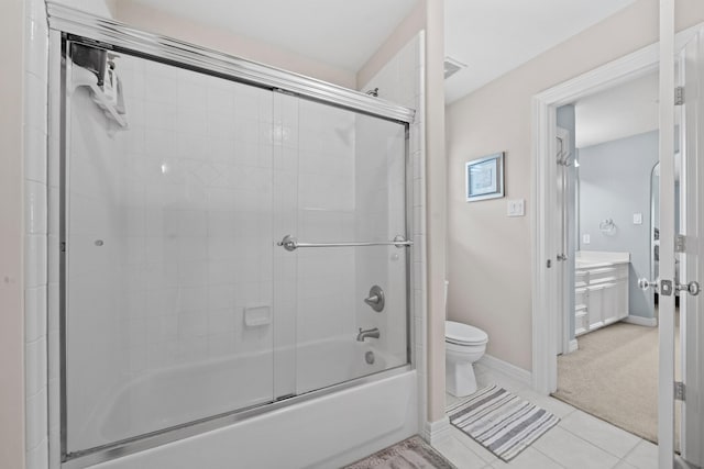 8910 Cote Ct, Houston, TX 77064 - full bathroom featuring toilet, shower / bath combination with glass door, baseboards, vanity, and tile patterned floors