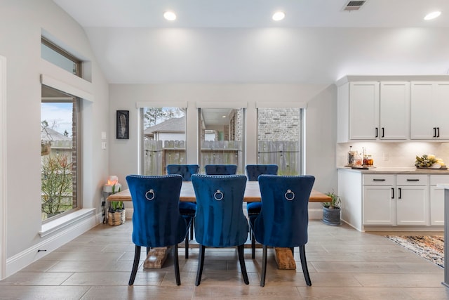 17185 Foxtrot Way, Conroe, TX 77302 - dining area featuring bar area, light wood-style flooring, recessed lighting, vaulted ceiling, and baseboards