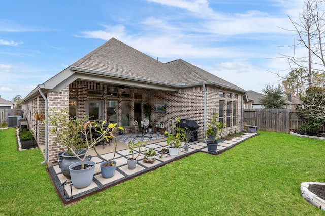 17185 Foxtrot Way, Conroe, TX 77302 - back of house with brick siding, roof with shingles, a patio area, and central AC