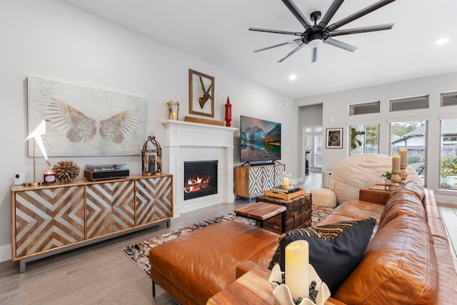 17185 Foxtrot Way, Conroe, TX 77302 - living room with a brick fireplace, a ceiling fan, recessed lighting, baseboards, and wood finished floors