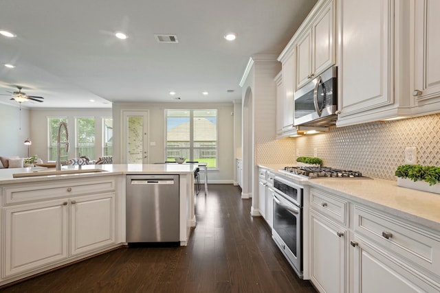 18735 Evanhale Bend Dr, Cypress, TX 77429 - kitchen featuring stainless steel appliances, a sink, dark wood-style flooring, light countertops, and backsplash