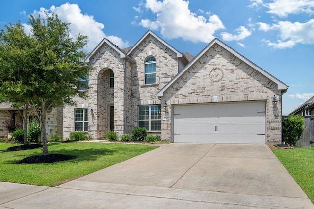 18735 Evanhale Bend Dr, Cypress, TX 77429 - view of front of home featuring brick siding, a front lawn, driveway, and an attached garage