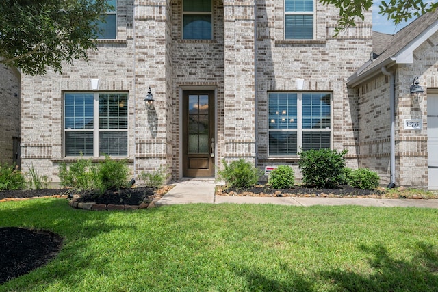 18735 Evanhale Bend Dr, Cypress, TX 77429 - doorway to property with a yard and brick siding