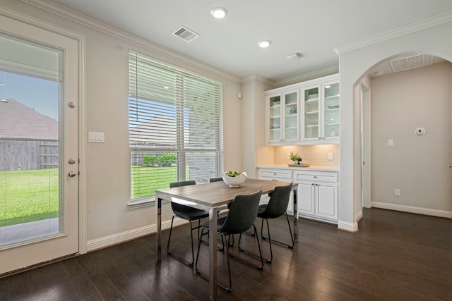 18735 Evanhale Bend Dr, Cypress, TX 77429 - dining room with dark wood-style floors, arched walkways, baseboards, crown molding, and recessed lighting