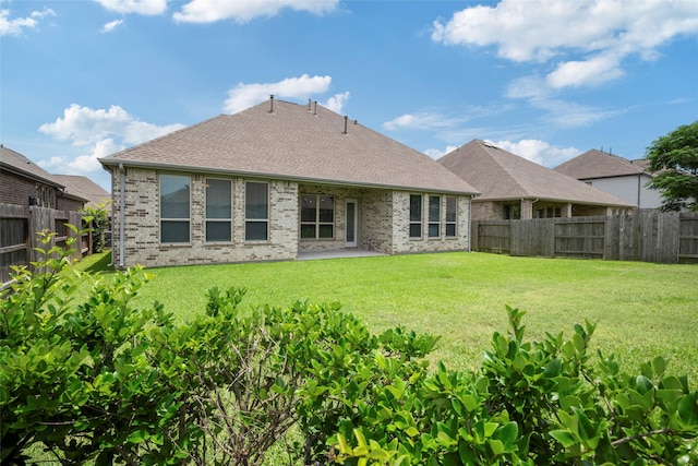 18735 Evanhale Bend Dr, Cypress, TX 77429 - back of property featuring brick siding, a patio area, and a shingled roof