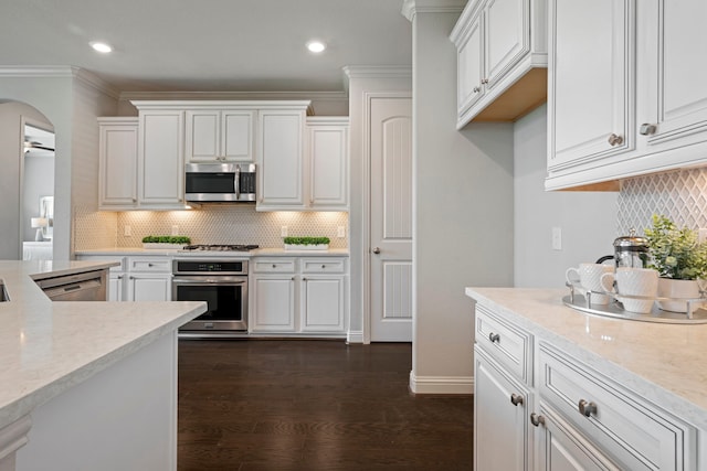 18735 Evanhale Bend Dr, Cypress, TX 77429 - kitchen with appliances with stainless steel finishes, white cabinets, dark wood-style flooring, recessed lighting, and ornamental molding