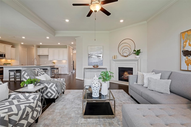 18735 Evanhale Bend Dr, Cypress, TX 77429 - living area featuring wood finished floors, a ceiling fan, ornamental molding, recessed lighting, and a warm lit fireplace