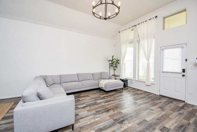 9311 Gilbert Hollow Dr, Rosenberg, TX 77469 - living room featuring a chandelier, wood finished floors, baseboards, and high vaulted ceiling
